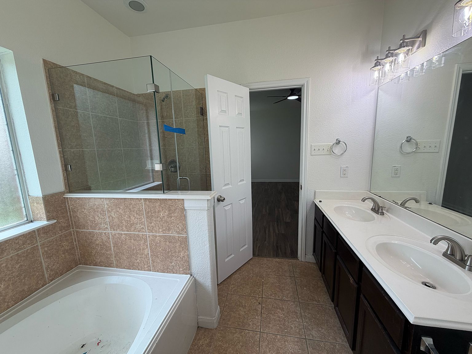Primary bath with glass shower and soaking tub